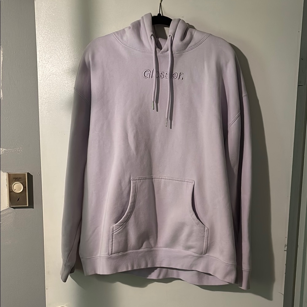 Glossier, Lavender hoodie in size XL. Embossed lettering, “Glossier”.